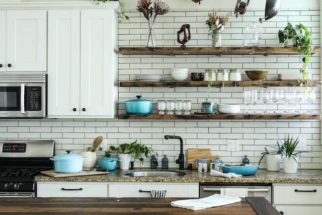 an industrial kitchen with brown wooden shelf
