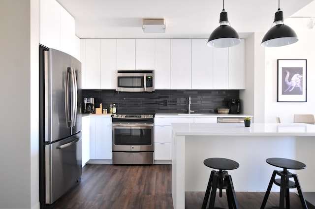 a monochrome kitchen with a grey 3-door refrigerator near a modular kitchen
