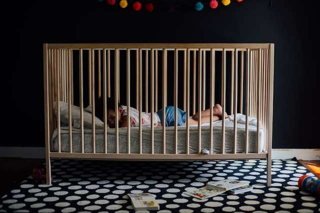 a toddler in a crib
