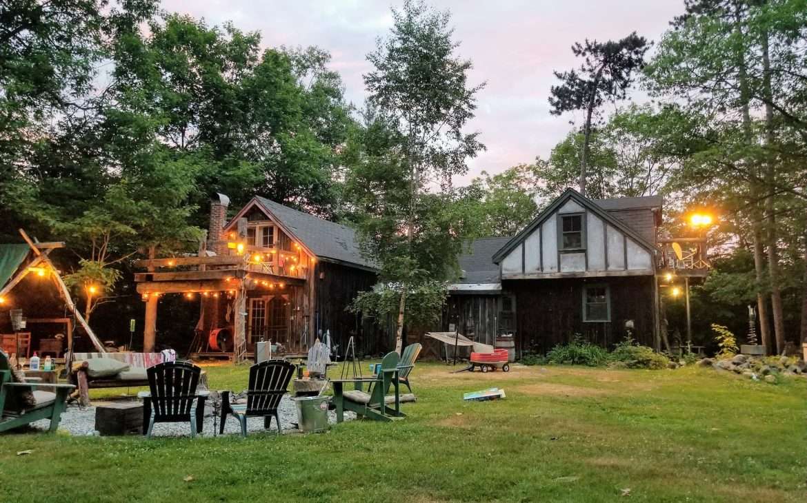 a backyard with chairs and turned-on lights