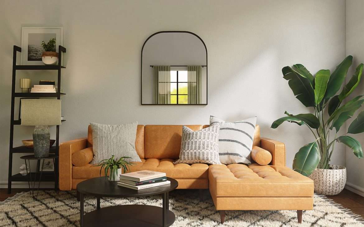  an orange sofa with a white rug beside a plant